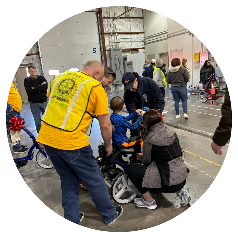 group of people helping children ride bicycles